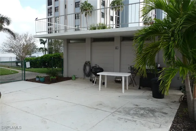 a view of a house with a patio and a yard