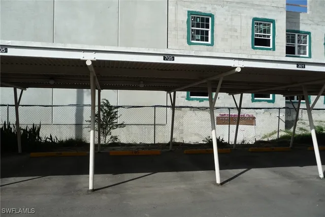 a black and white photo of a room with wooden floor