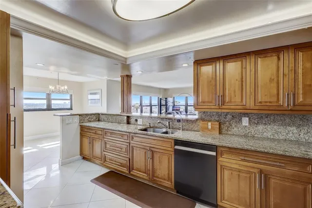 a kitchen with stainless steel appliances granite countertop a sink stove and cabinets