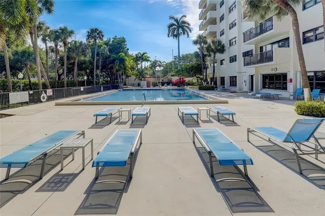 a view of a swimming pool with lounge chair