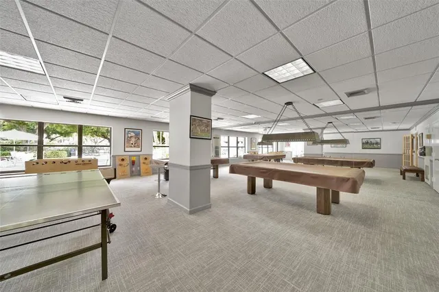 a view of game room with windows