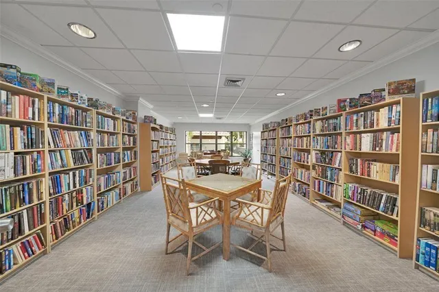a view of a dining room with furniture and a book shelf