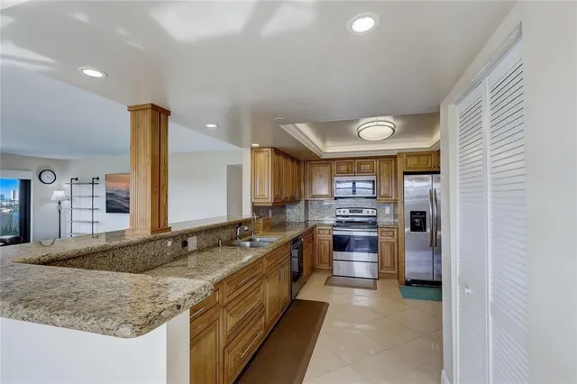 a kitchen with stainless steel appliances granite countertop a sink and cabinets