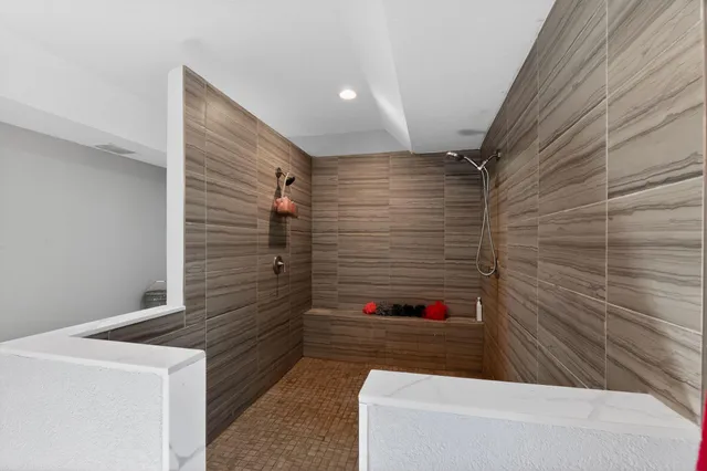 a bathroom with a shower and a sink