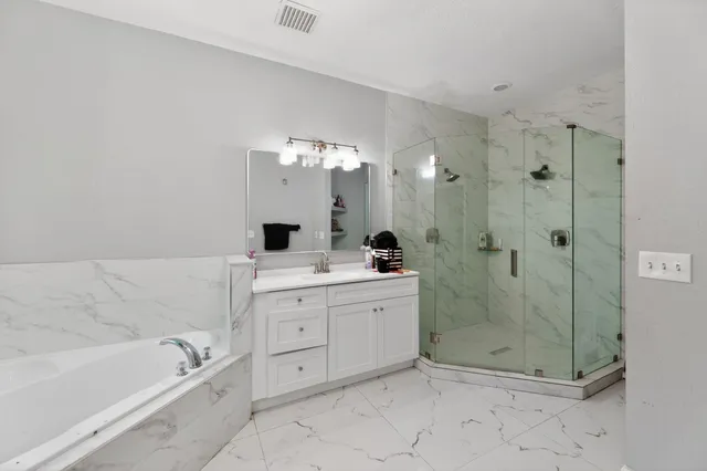 a bathroom with a double vanity sink toilet and shower