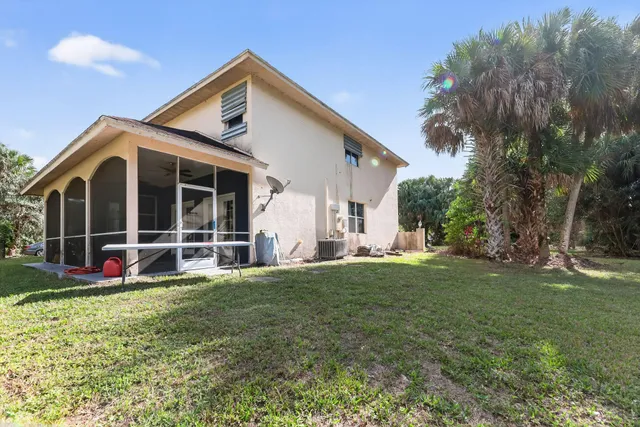 a view of a house with a yard and sitting area