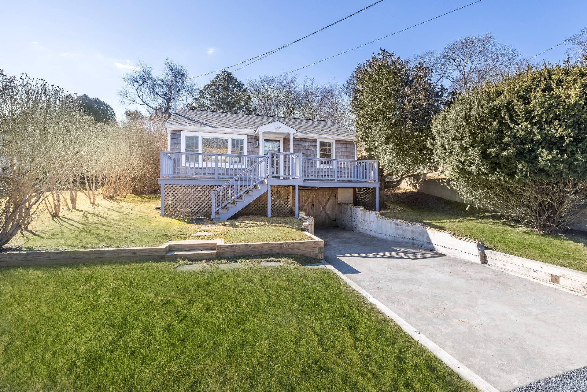 63 2nd House Road Montauk, NY 11954 - Photo 2 of 14 a front view of a house with a yard and garage
