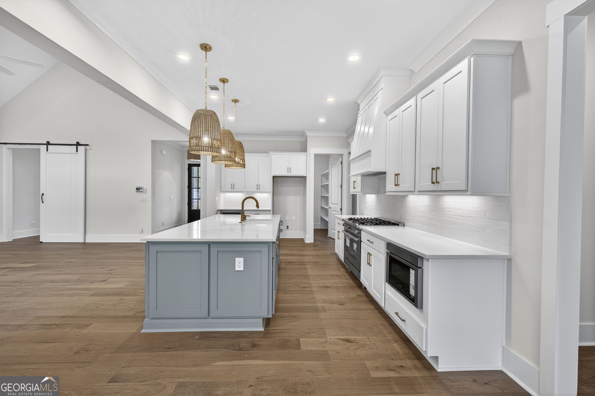 1020 Oak Valley Road Greensboro, GA 30642 - Photo 14 of 64 a large kitchen with stainless steel appliances granite countertop a lot of counter space and wooden floors