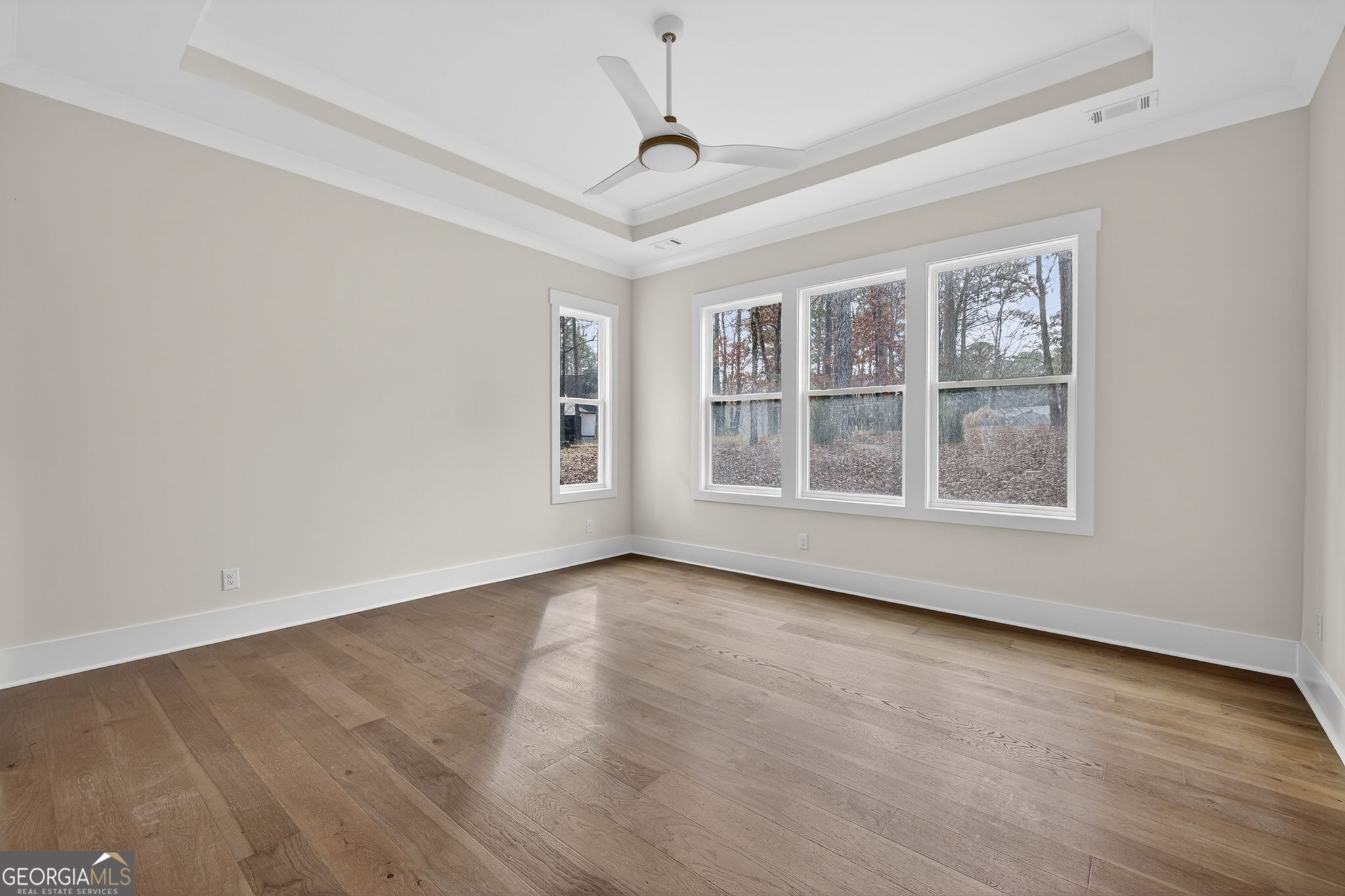 1020 Oak Valley Road Greensboro, GA 30642 - Photo 21 of 64 a view of an empty room with a window and wooden floor