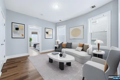 a living room with furniture and wooden floor