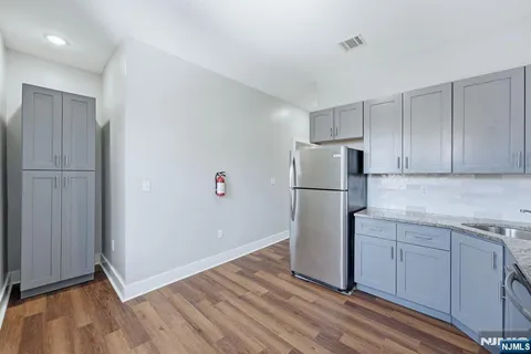 a view of a kitchen with a refrigerator a microwave and cabinets