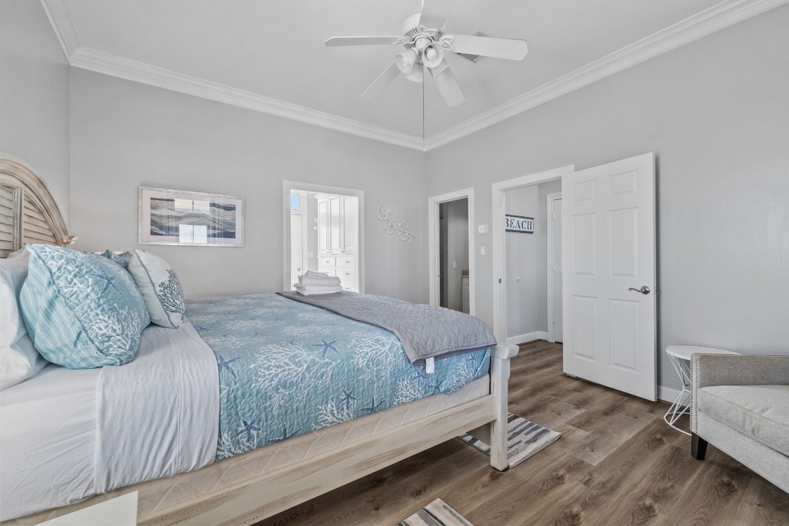 522 Dolphin Drive Freeport, TX 77541 - Photo 26 of 47 a bedroom with a large bed and wooden floor