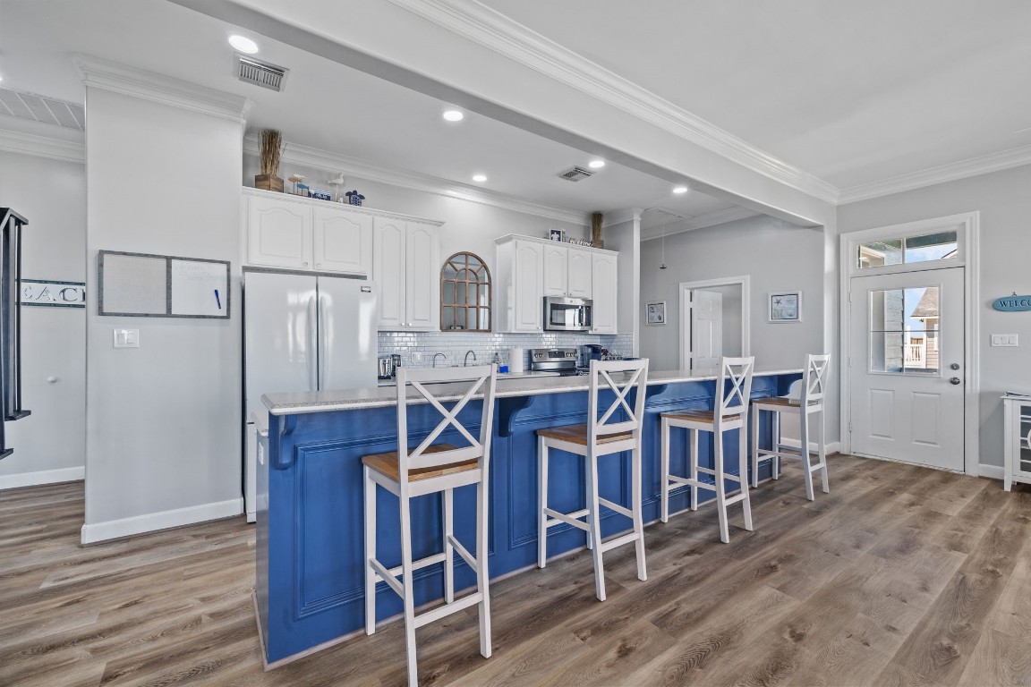 522 Dolphin Drive Freeport, TX 77541 - Photo 35 of 47 a open kitchen with stainless steel appliances refrigerator dining table and chairs