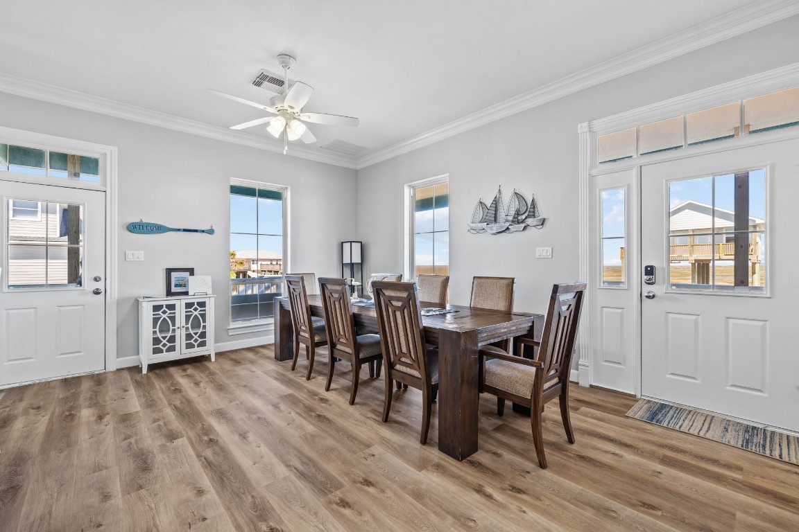 522 Dolphin Drive Freeport, TX 77541 - Photo 40 of 47 a view of a dining room with furniture and wooden floor