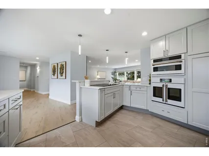 a kitchen with stainless steel appliances kitchen island granite countertop a stove top oven and sink