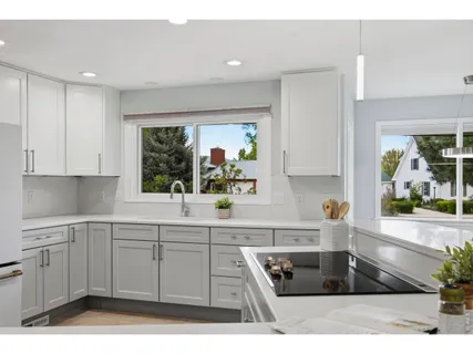 a kitchen with stainless steel appliances kitchen island granite countertop a sink stove and cabinets