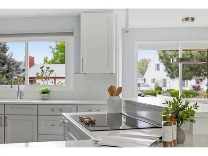 a kitchen with a window a sink and cabinets