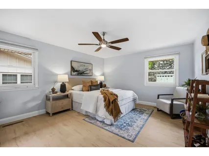 a bedroom with furniture and a large window