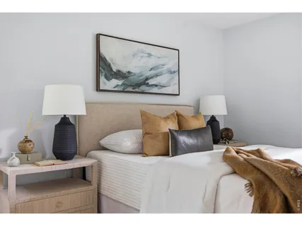 a bed room with a bed and a lamp