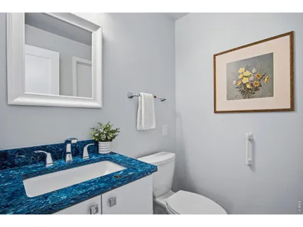 a bathroom with a granite countertop sink a mirror and vanity