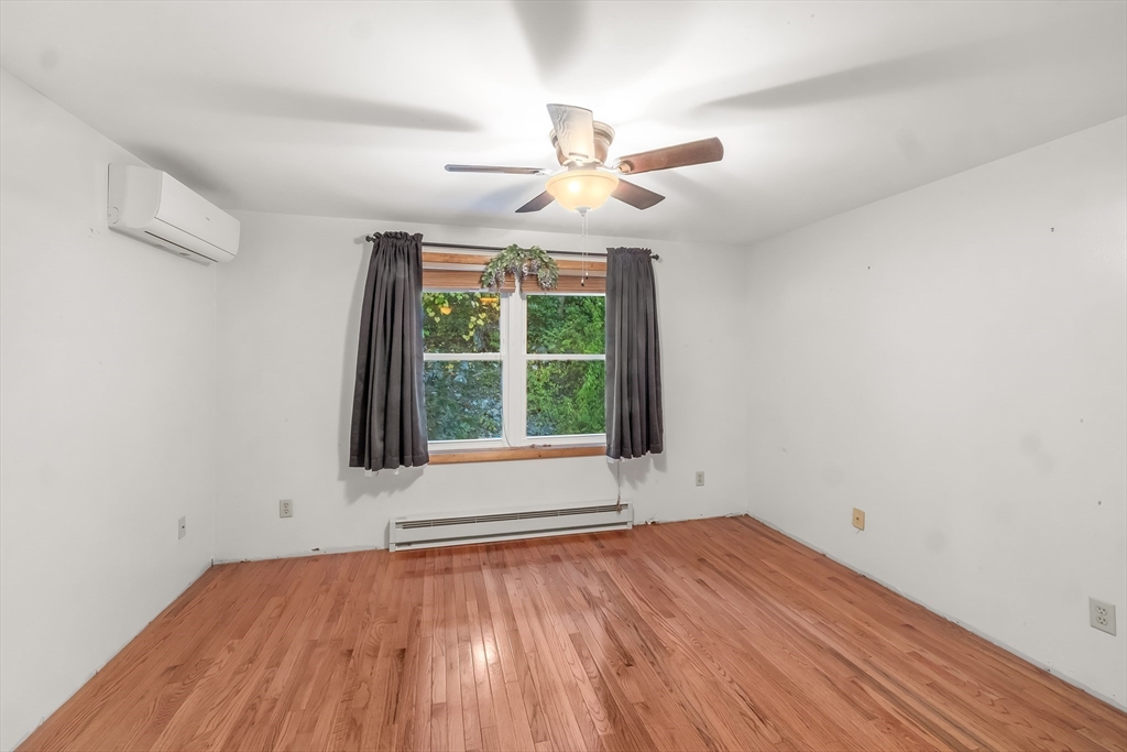 29 A Chilmark Street Worcester, MA 01604 - Photo 13 of 25 an empty room with wooden floor chandelier fan and windows