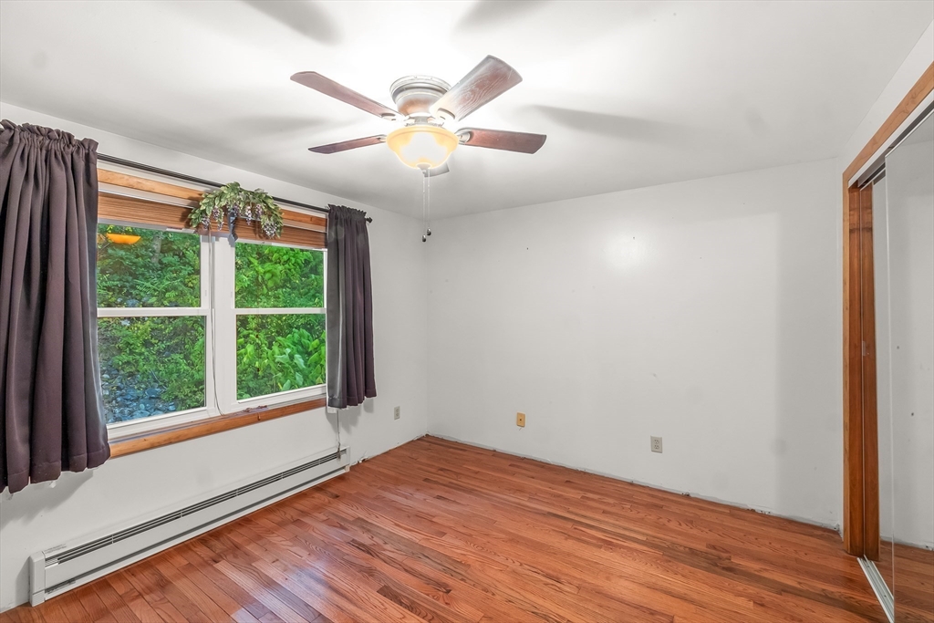 29 A Chilmark Street Worcester, MA 01604 - Photo 14 of 25 an empty room with wooden floor fan and windows