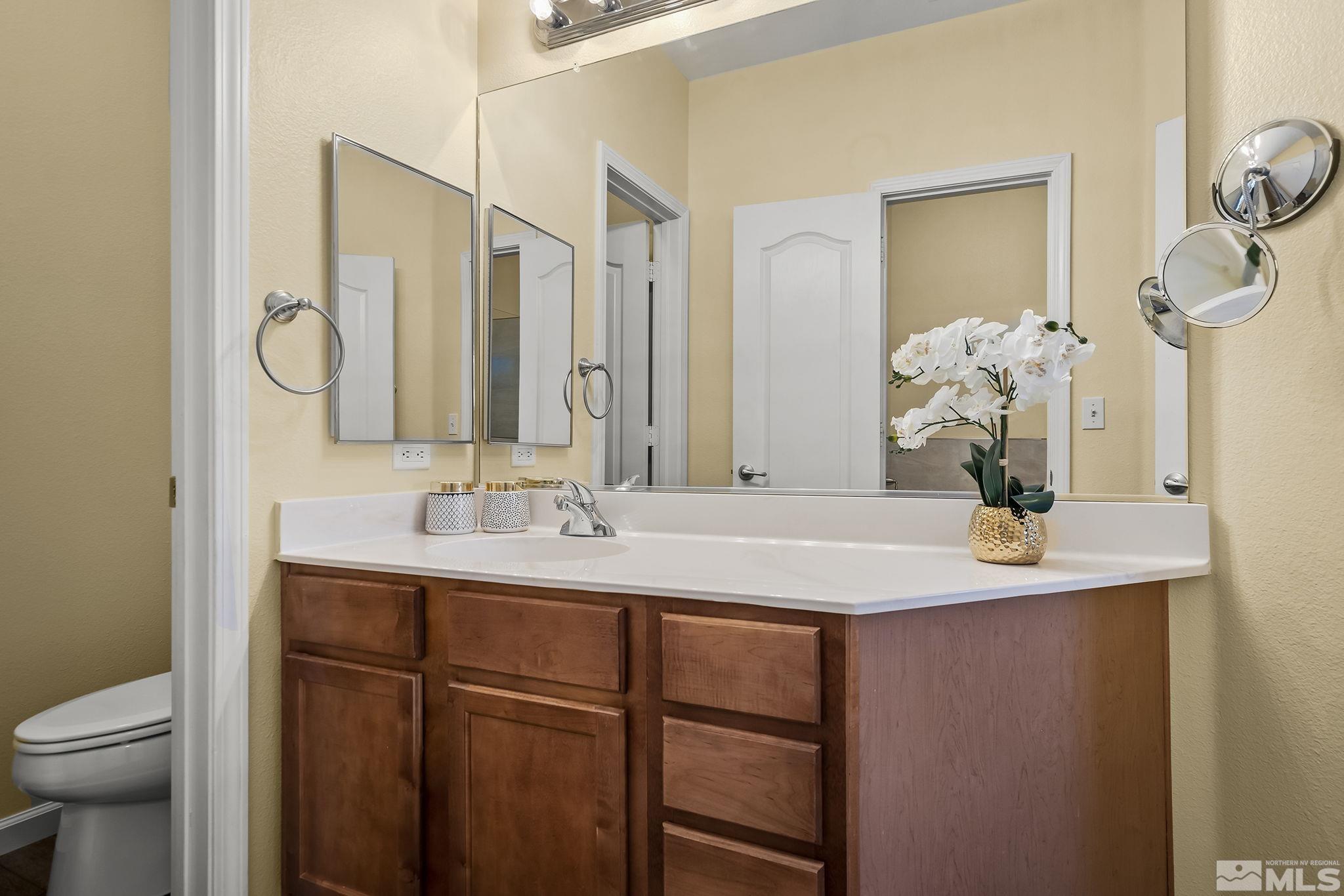9050 Double R Boulevard, Unit 1622 Reno, NV 89511 - Photo 16 of 25 a bathroom with a sink double vanity and a mirror