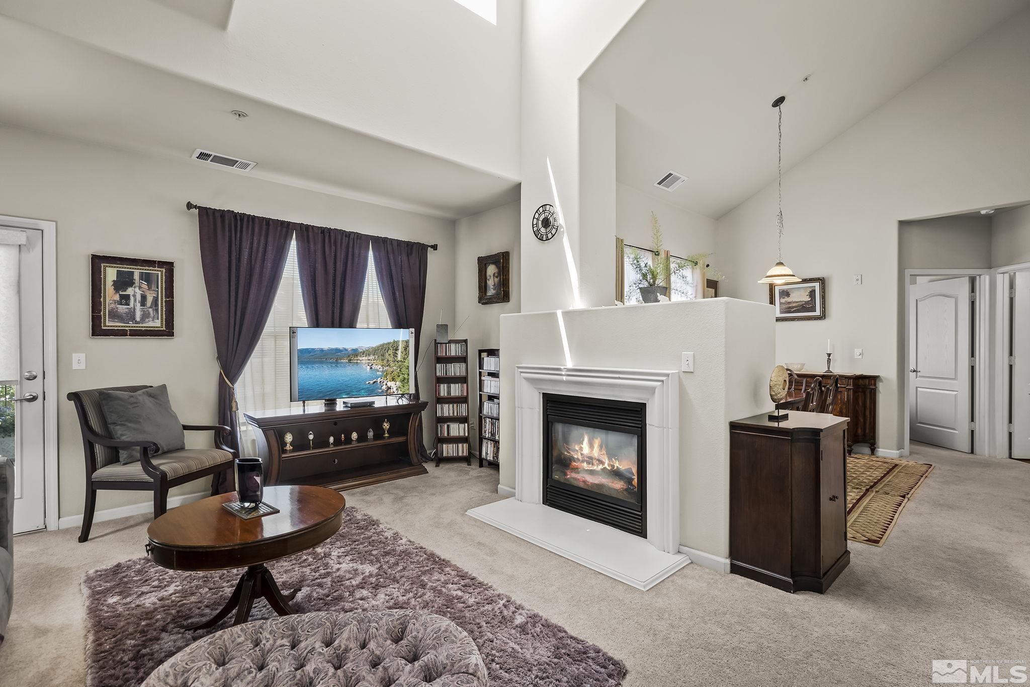 9050 Double R Boulevard, Unit 1622 Reno, NV 89511 - Photo 4 of 25 a living room with furniture and a fireplace
