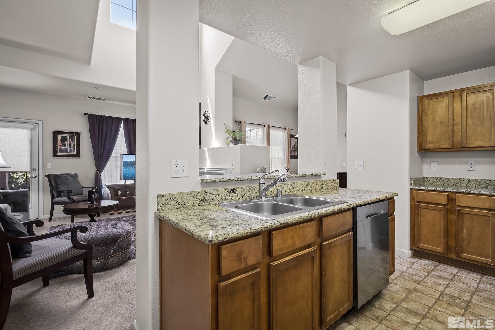 9050 Double R Boulevard, Unit 1622 Reno, NV 89511 - Photo 8 of 25 a kitchen with a sink stove and cabinets