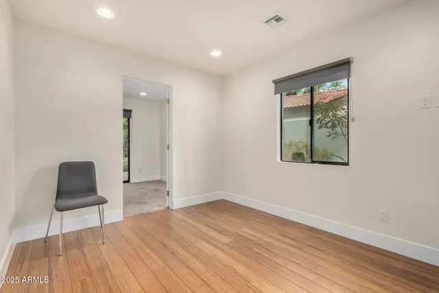 a view of room with window and wooden floor