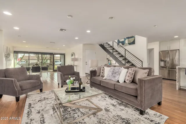 a living room with furniture or wooden floor and a large window