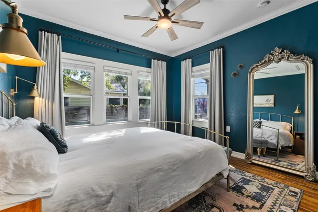 a bedroom with a large bed and a chandelier