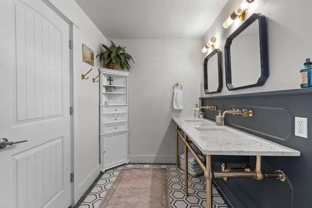 a bathroom with a sink a vanity and a mirror