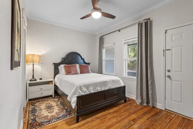 a bedroom with a large bed and a chandelier