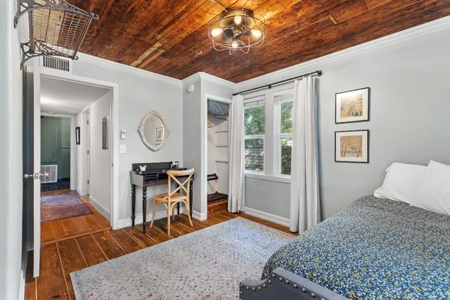 a bedroom with furniture and wooden floor
