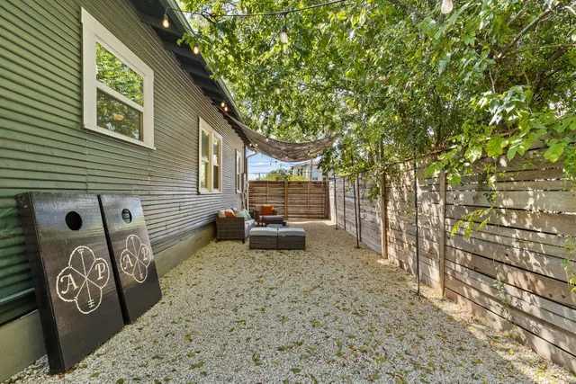 a view of a backyard with table and chairs and a barbeque