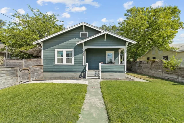 a front view of house with yard and green space