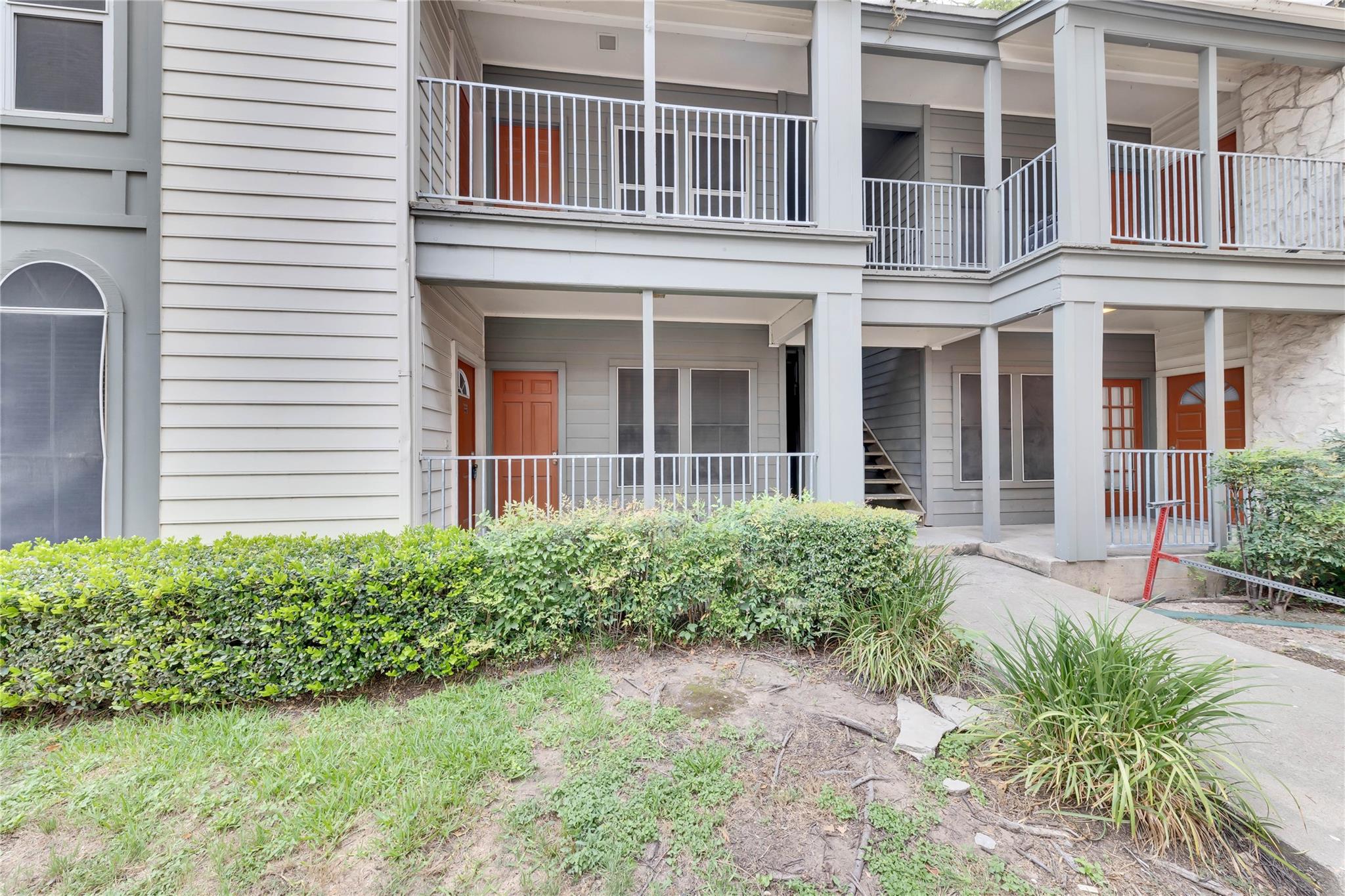 2529 Rio Grande Street, Unit 100 Austin, TX 78705 - Photo 6 of 14 front view of a brick house with a yard