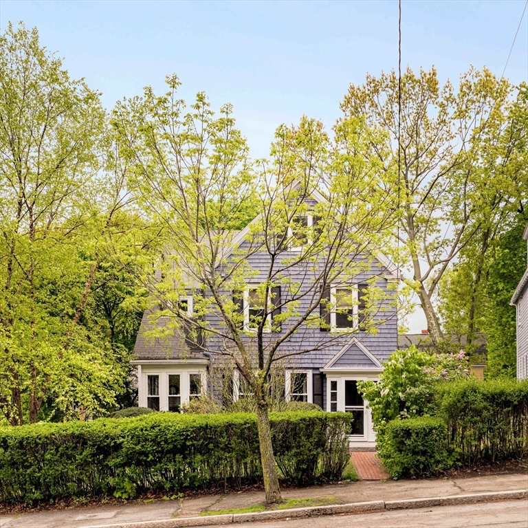 a front view of a house with a garden