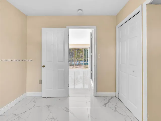 a bathroom with a granite countertop toilet sink and mirror