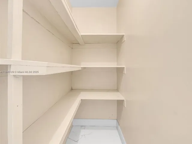 a view of kitchen with furniture and cabinets