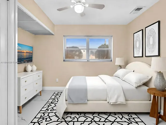 a bathroom with a granite countertop toilet sink and mirror