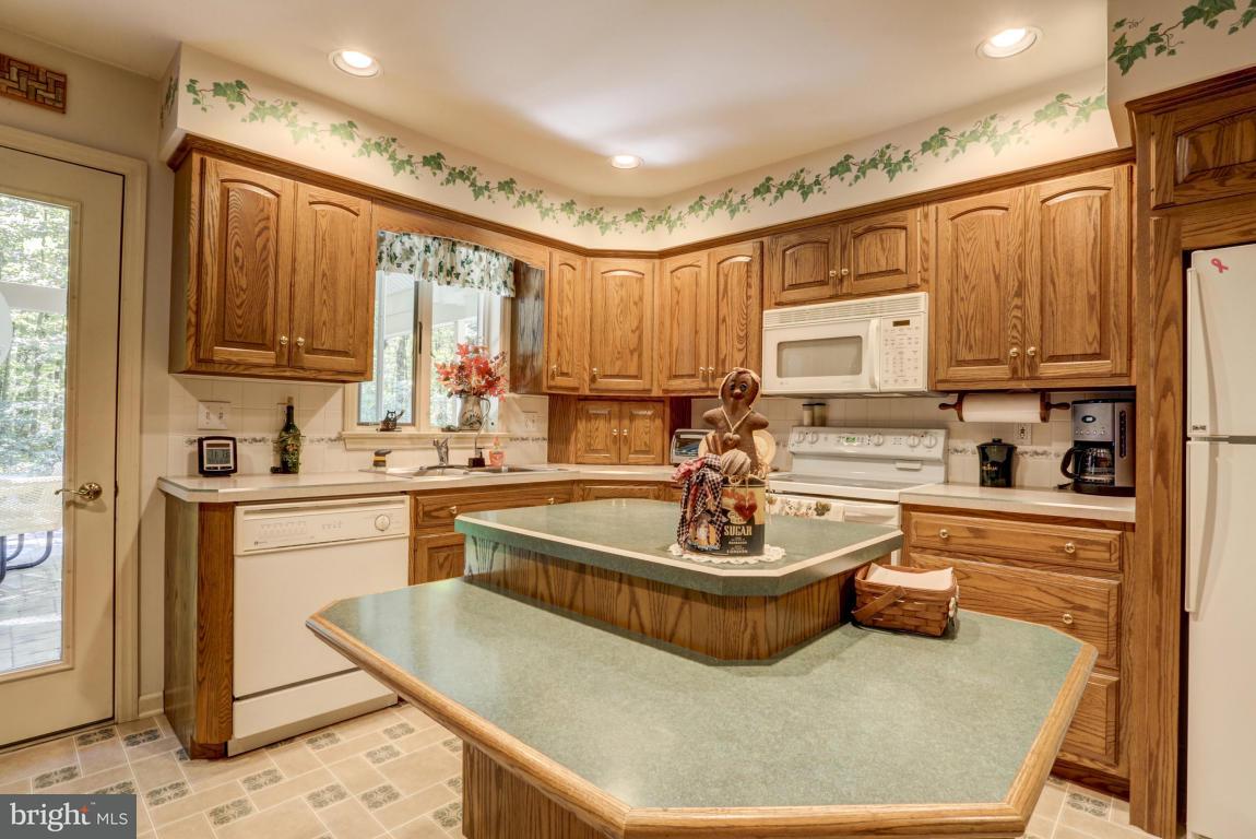 1136 Ranck Road New Holland, PA 17557 - Photo 14 of 37 a kitchen with a white stove top oven and cabinets