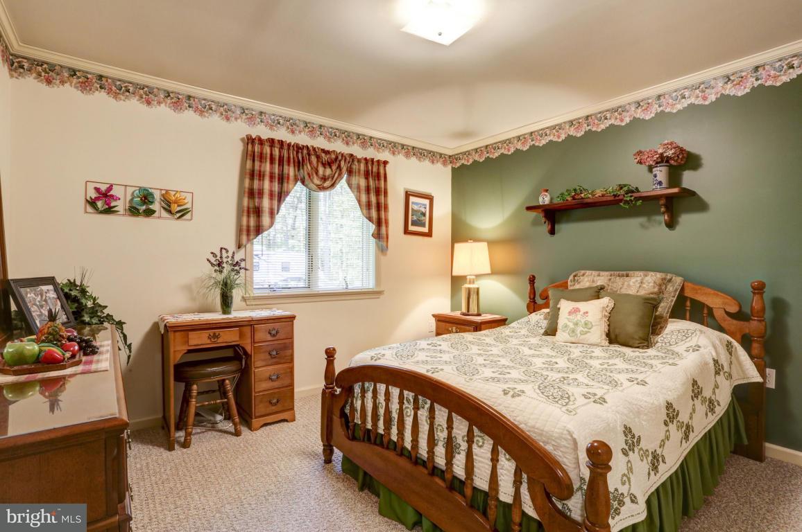 1136 Ranck Road New Holland, PA 17557 - Photo 22 of 37 a bedroom with a bed a table and chair