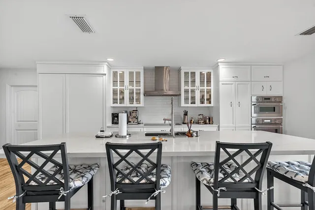 a bathroom with a sink toilet a mirror and shower