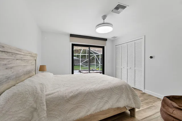 a bedroom with a large bed and a large window with outer view