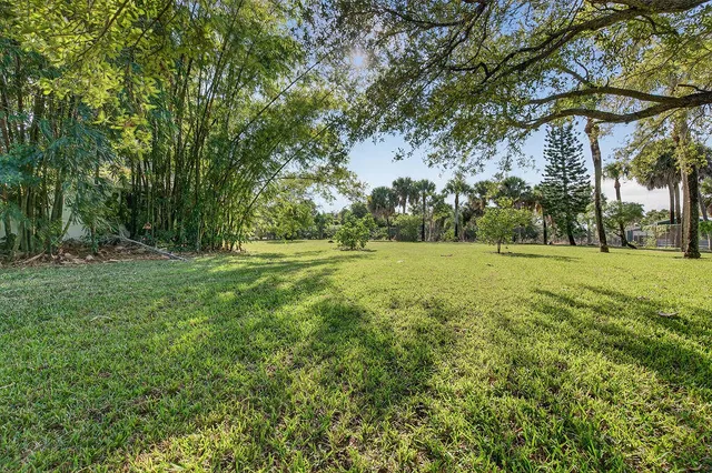 an aerial view of residential houses with outdoor space and swimming pool