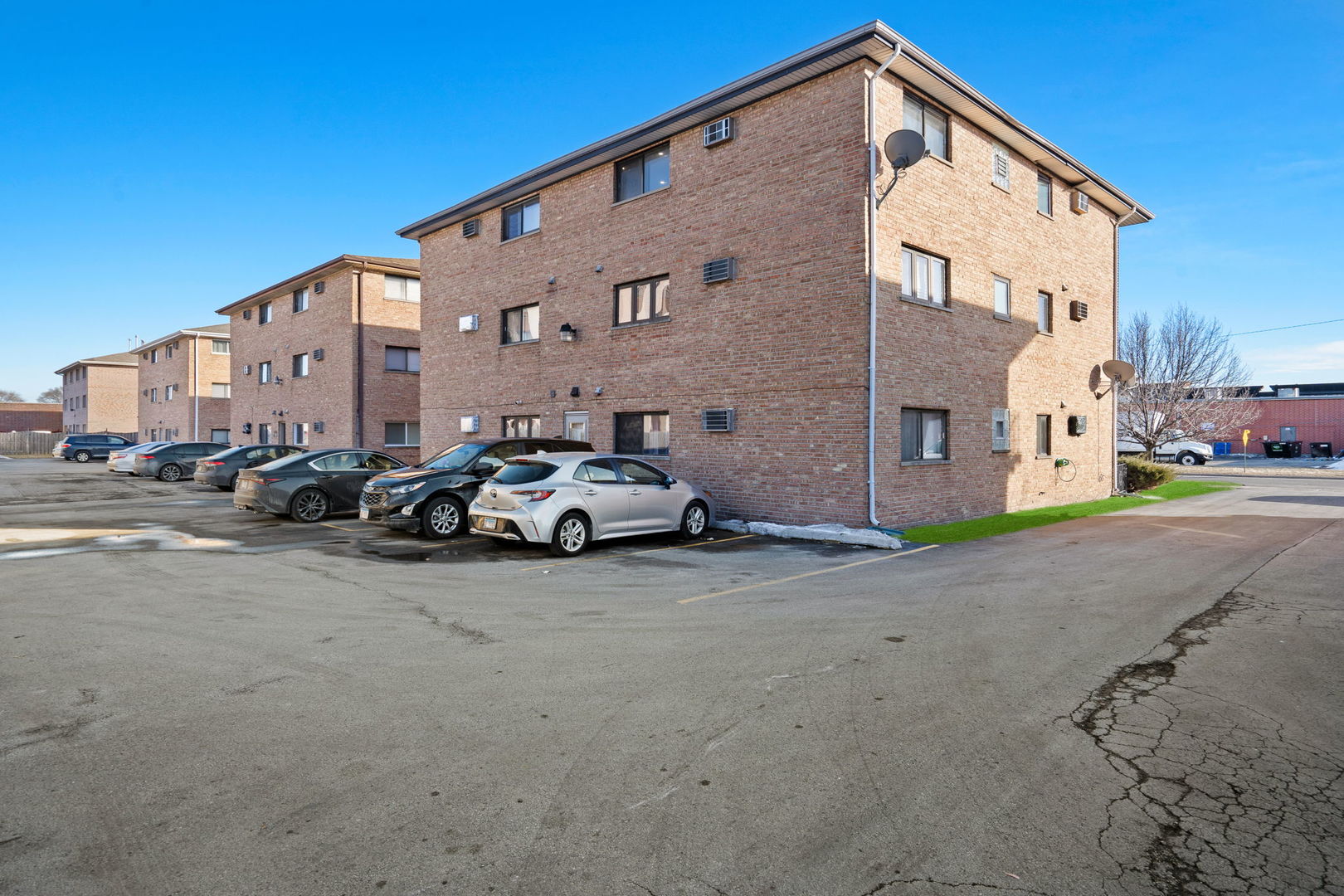 7242 West 86th Street, Unit 3A Bridgeview, IL 60455 - Photo 13 of 14 a couple of cars parked in front of a house