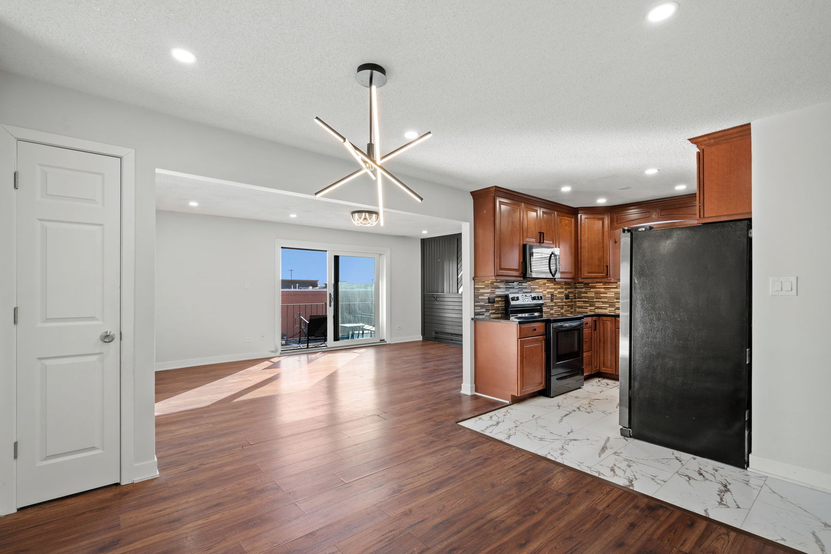 7242 West 86th Street, Unit 3A Bridgeview, IL 60455 - Photo 4 of 14 a view of a kitchen with refrigerator and wooden floor
