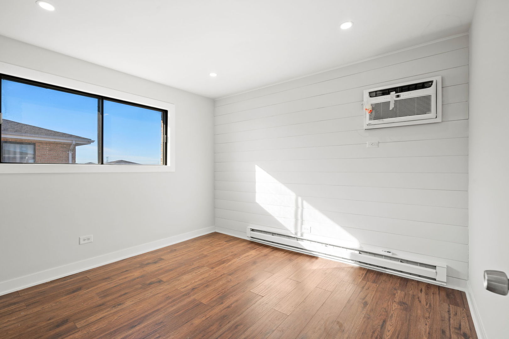 7242 West 86th Street, Unit 3A Bridgeview, IL 60455 - Photo 10 of 14 an empty room with wooden floor and windows